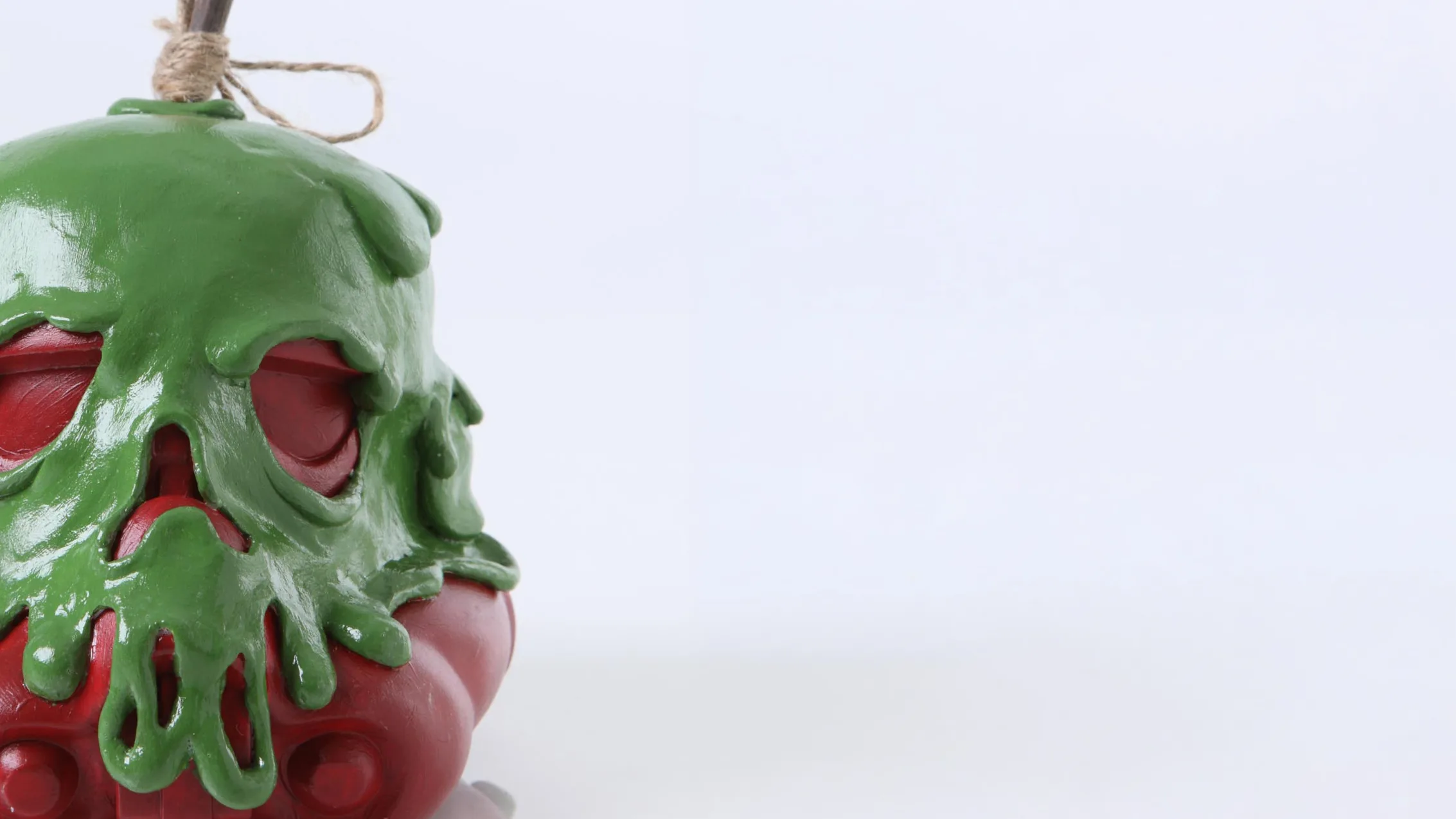 Painted skull sculpture with green drip finish